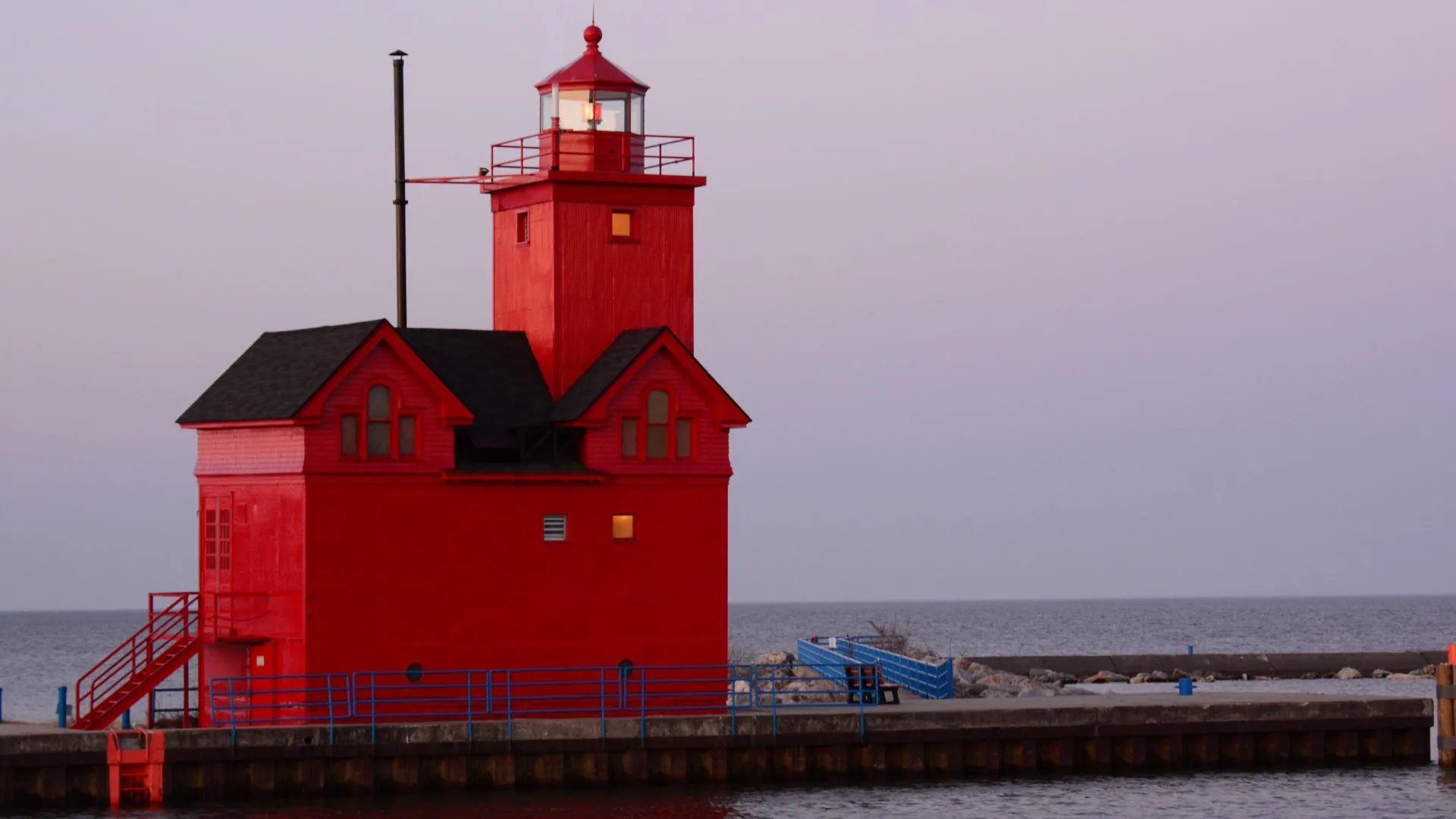 Holland Michigan Red Lighthouse A red dutch-styled light house on a body water