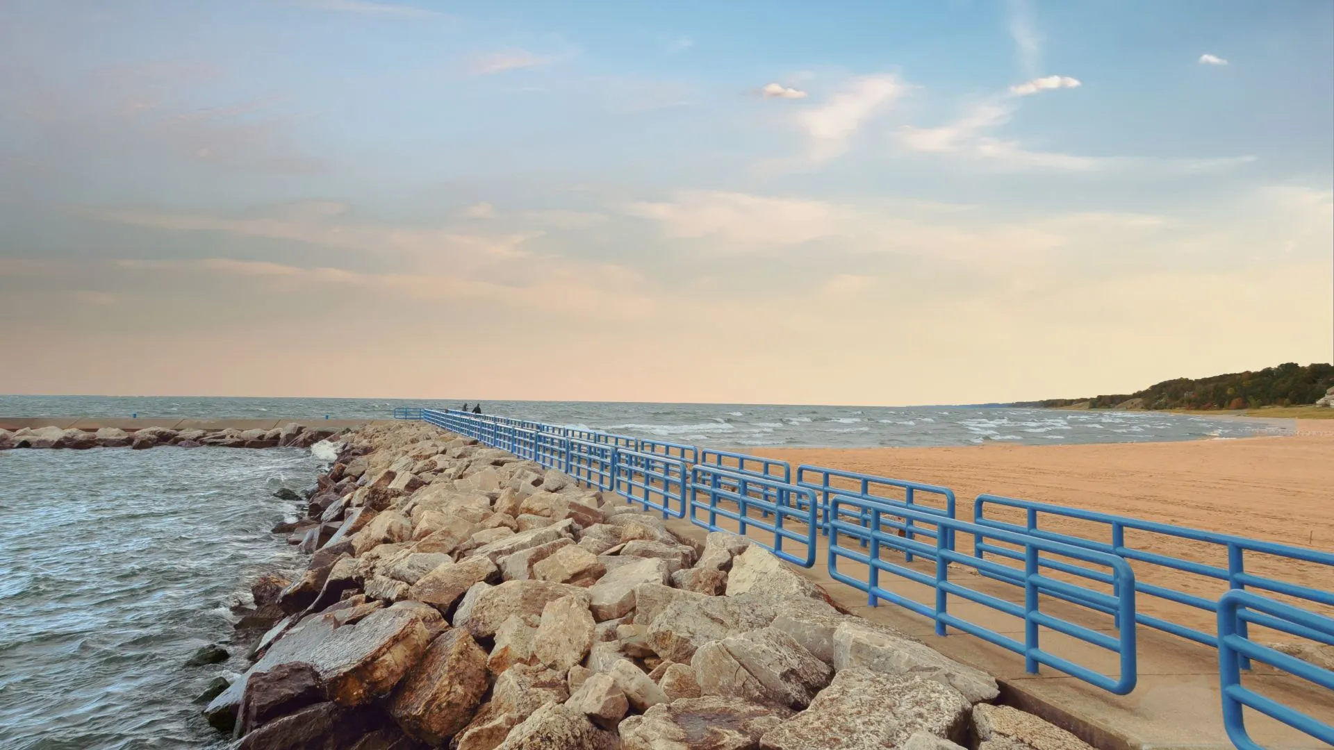 Holland Michigan Scenic Trails A rocky outcrop with railings; beach on one side and water on the other