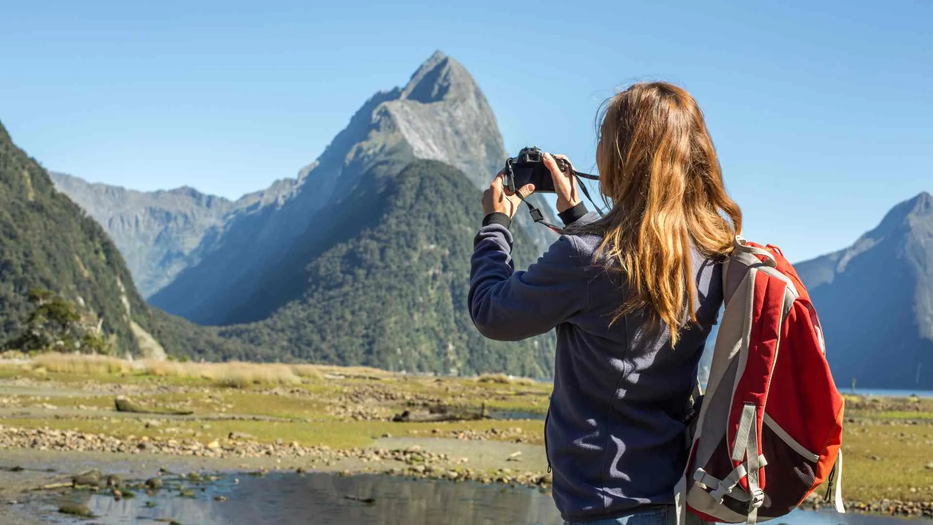Milford Sound Cruising (16) girl taking picture in Milford Sound